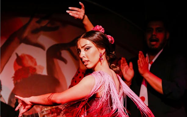 Flamenco dancer performing at El Duende by Tablao Cordobes show in vibrant attire.