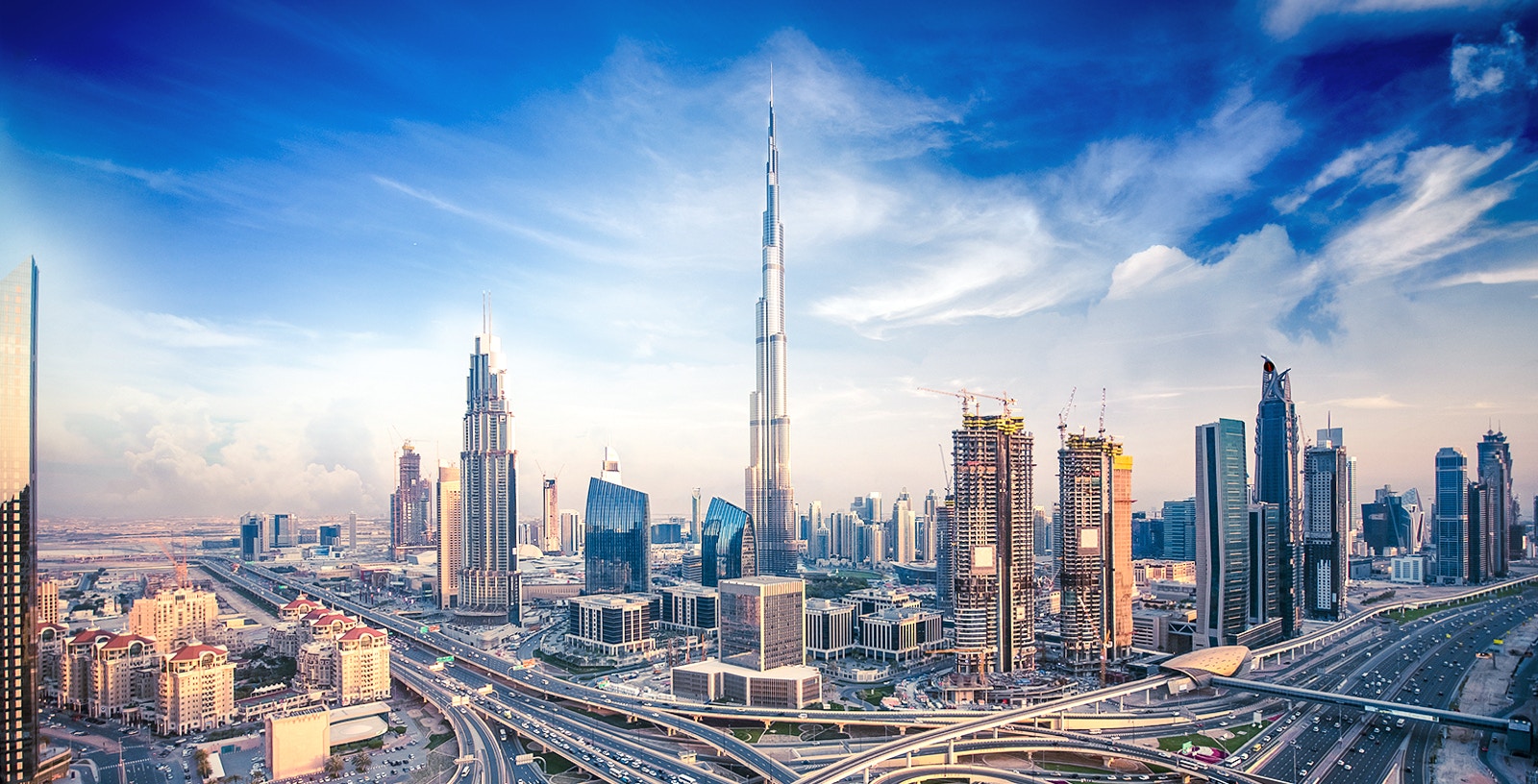 Burj Khalifa towering over Dubai skyline with surrounding cityscape.