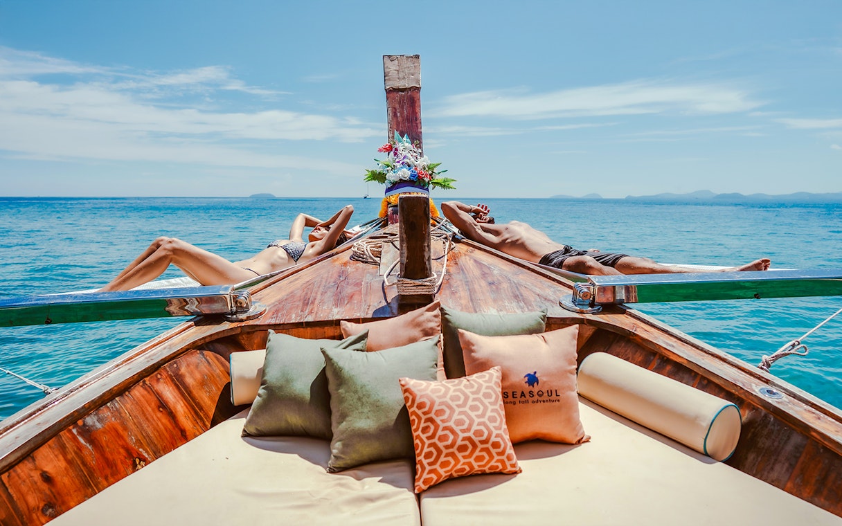 People relaxing on a luxury longtail boat cruise in Krabi, Thailand.