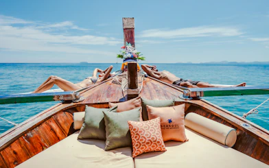 People relaxing on a luxury longtail boat cruise in Krabi, Thailand.