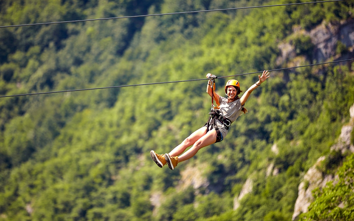 Ziplining adventure in Antalya with lush green forest backdrop.