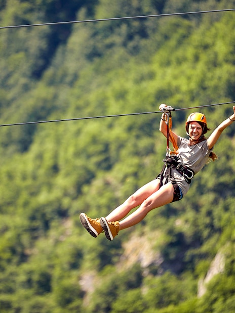 Ziplining adventure in Antalya with lush green forest backdrop.