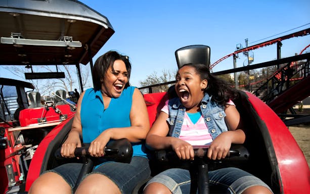Riders enjoying the Pandemonium roller coaster at Six Flags Over Texas.
