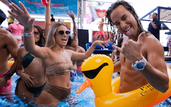 Partygoers enjoying Coco Bongo Beach Party with inflatable duck in pool.