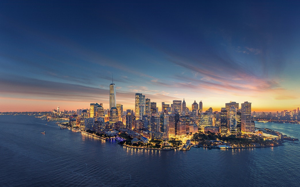 Aerial view of Manhattan skyline at sunset with One World Trade Center.