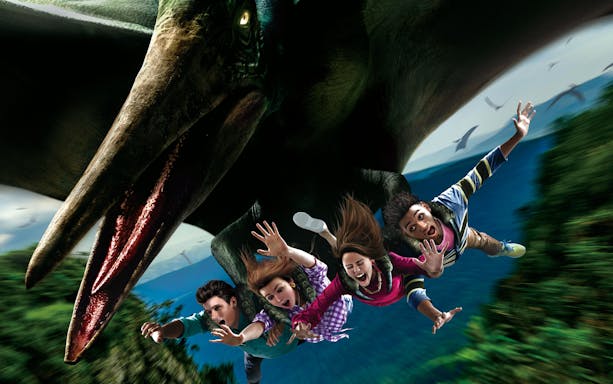 Visitors on a flying dinosaur ride at Universal Studios Japan.