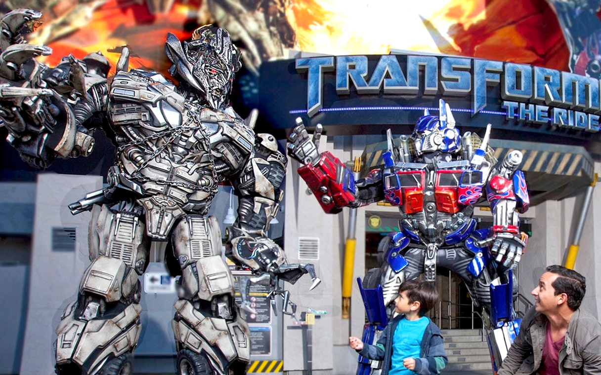 Transformers characters at Universal Studios Hollywood with visitors in front of the ride entrance.