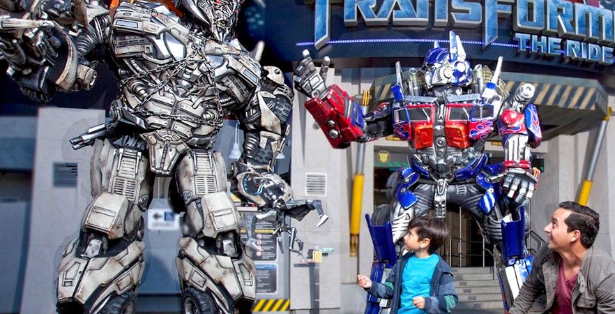Transformers characters at Universal Studios Hollywood with visitors in front of the ride entrance.