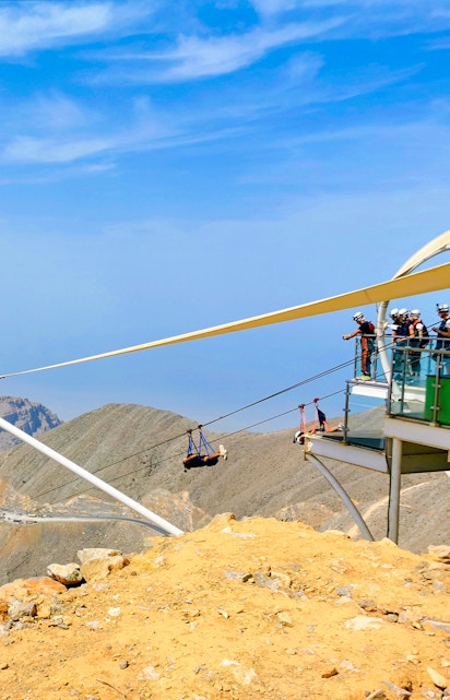 Zipline riders launch from Jebel Jais platform in Ras Al Khaimah, UAE.