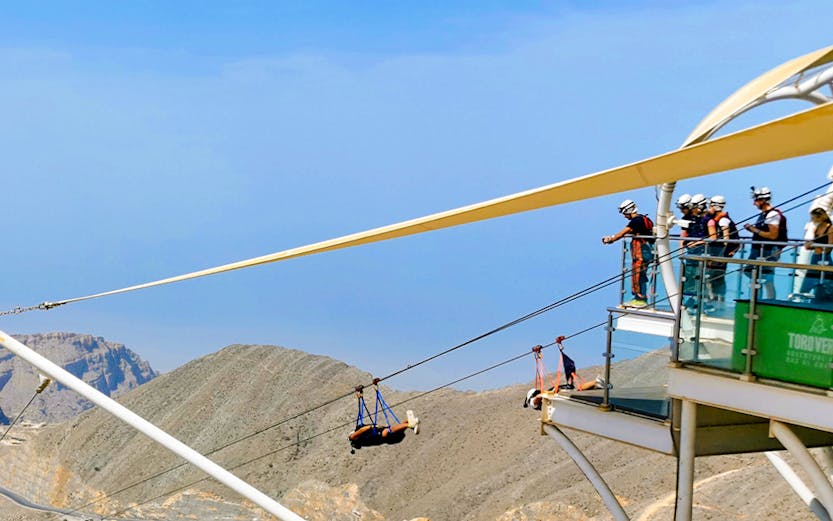 Zipline riders launch from Jebel Jais platform in Ras Al Khaimah, UAE.