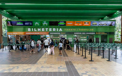 Entrance ticket counter at São Paulo Zoo with visitors in line.