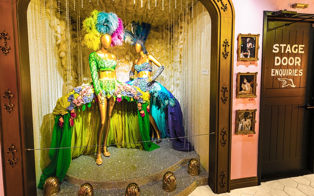 Broadway costume display with feathered headdresses at The Museum Of Broadway.