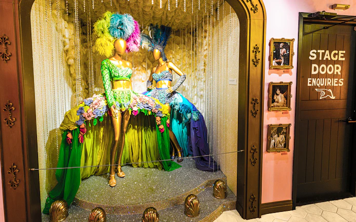 Broadway costume display with feathered headdresses at The Museum Of Broadway.