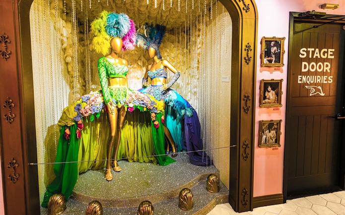 Broadway costume display with feathered headdresses at The Museum Of Broadway.