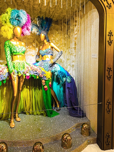 Broadway costume display with feathered headdresses at The Museum Of Broadway.