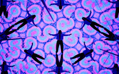 Person surrounded by kaleidoscopic mirrors at House of Hype, Dubai.