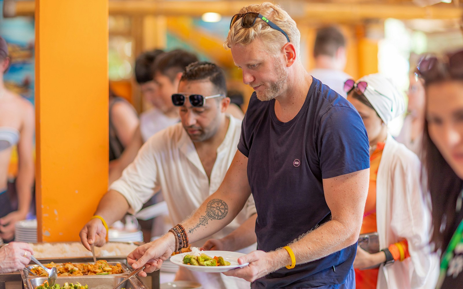 Passengers enjoying buffet lunch on Phi Phi Don Island with scenic ocean view.