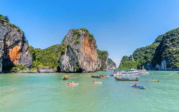 Canoeing through limestone cliffs at Koh Hong Island, Phang Nga, Thailand.