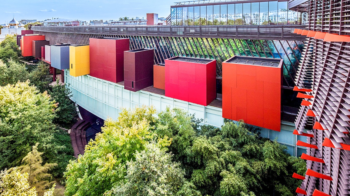 Visitors exploring exhibits at Musée du quai Branly, Paris, showcasing indigenous art and cultures.
