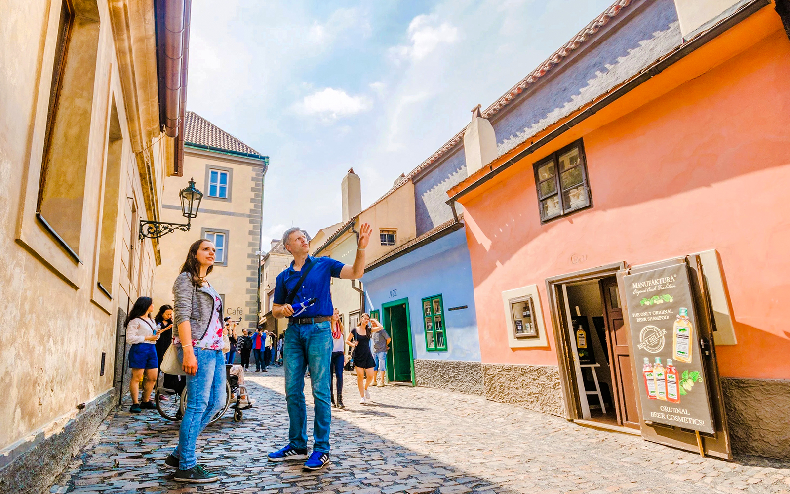 Prague Castle with tourists exploring Golden Lane during a guided tour.