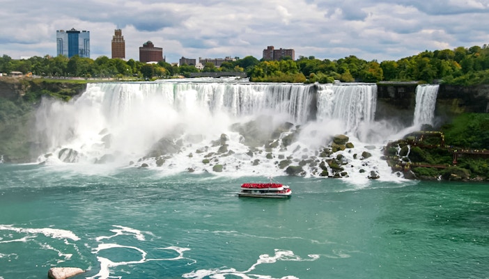 Boat approaching Niagara Falls with mist rising, Canada.
