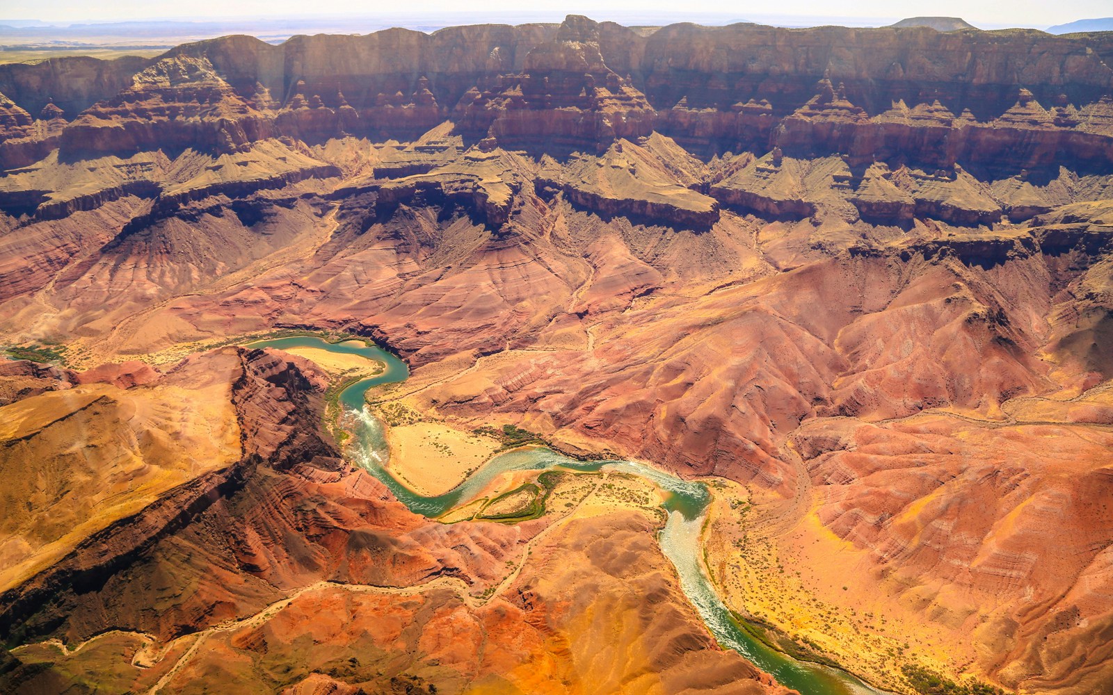 Aircraft flying over the Grand Canyon with a view of the canyon's vast landscape.