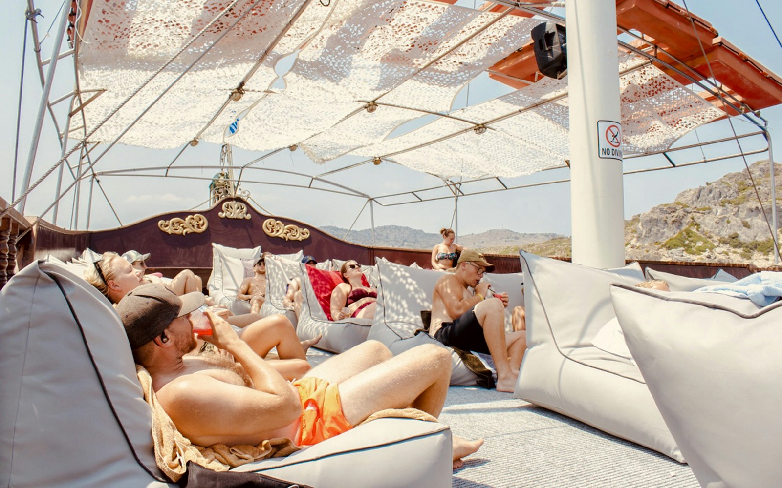 Guests relaxing and drinking on a day cruise from Rhodes.