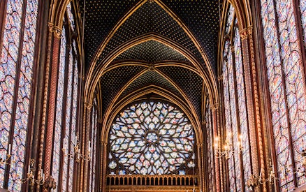 Stained glass windows in Sainte-Chapelle, Paris, showcasing intricate designs and vibrant colors.