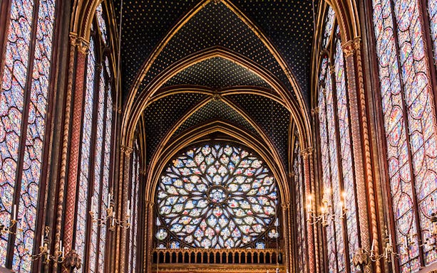Stained glass windows in Sainte-Chapelle, Paris, showcasing intricate designs and vibrant colors.