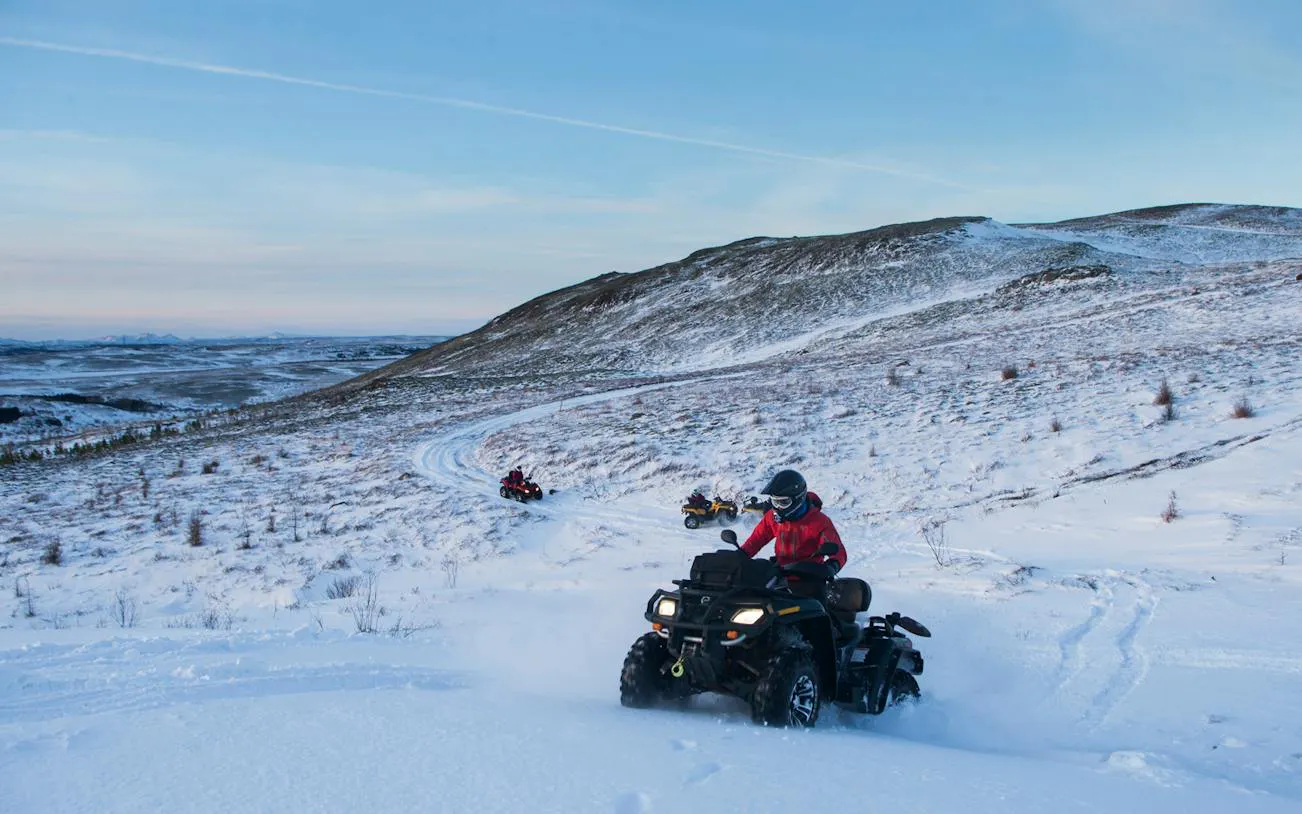 ATVs driving through snowy terrain on Twin Peaks tour near Reykjavik.
