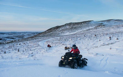 ATVs driving through snowy terrain on Twin Peaks tour near Reykjavik.