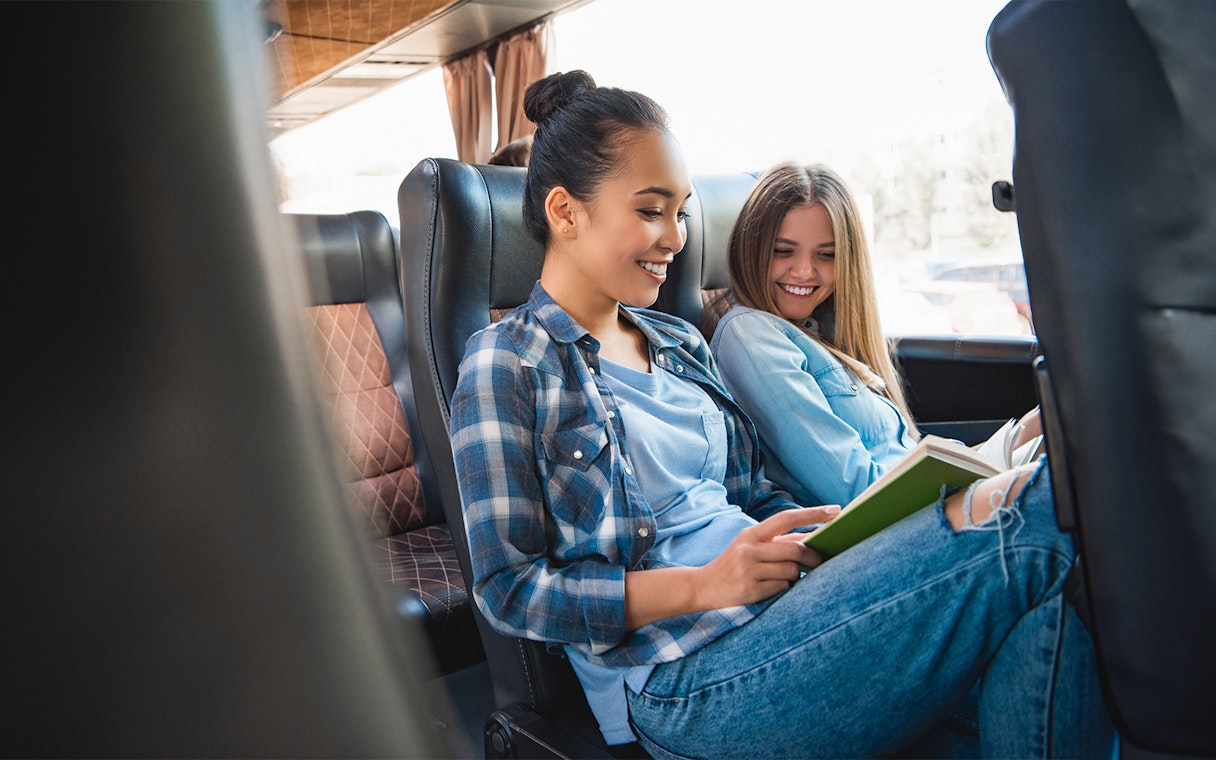 Friends reading on a bus to Puy Du Fou.