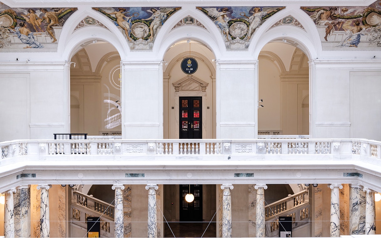Interior arches and frescoes of New Hofburg Palace, Vienna, Austria.