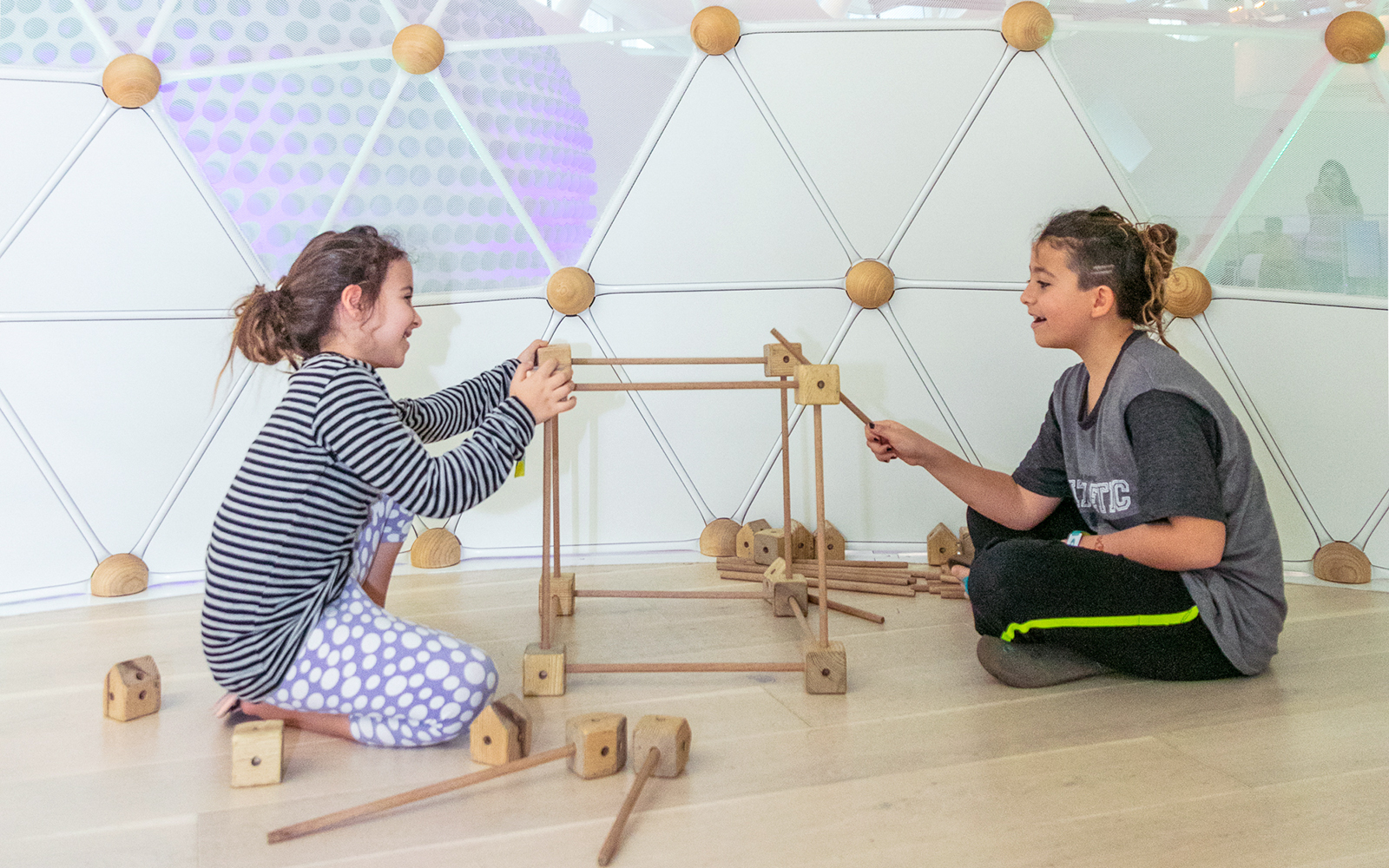 Children building with wooden blocks at Museum of The Future, Dubai.
