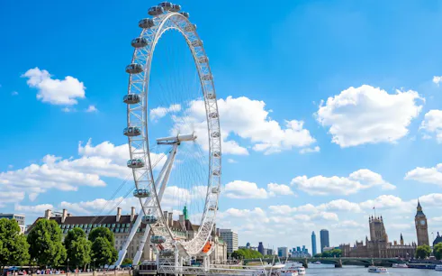London Eye and Big Ben viewed from the Thames on a sunny day during a private chauffeur-driven tour.