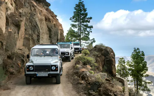 White 4x4 vehicles on narrow dirt road, Gran Canaria Jeep Safari.