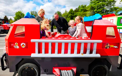 Guests enjoying a fire truck ride at LEGOLAND Billund.