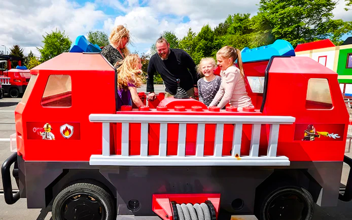 Guests enjoying a fire truck ride at LEGOLAND Billund.