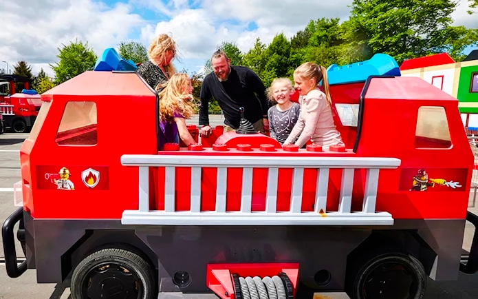 Guests enjoying a fire truck ride at LEGOLAND Billund.