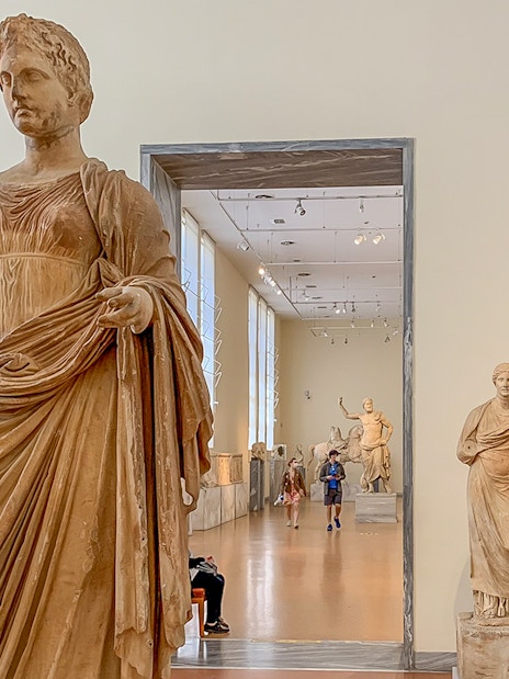 Exhibits of ancient statues inside the National Archaeological Museum.