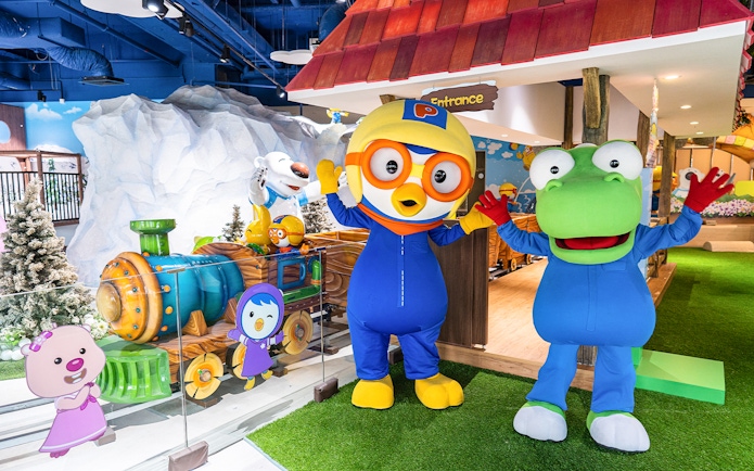 Pororo and friends at Pororo Park Singapore with colorful train and snowy backdrop.