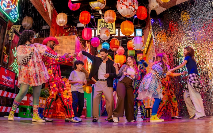 Group dancing under colorful lanterns at House Of Hype.