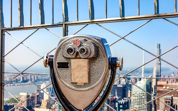 Observation deck viewfinder overlooking New York City skyline on Empire State Building Walking Tour.