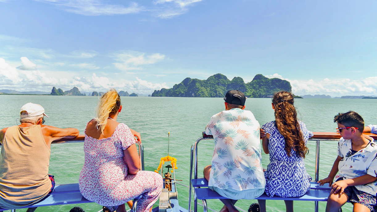 Tourists on a boat viewing James Bond Island and Phang Nga Bay, Thailand.