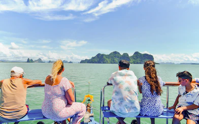 Tourists on a boat viewing James Bond Island and Phang Nga Bay, Thailand.