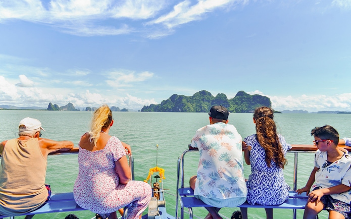 Tourists on a boat viewing James Bond Island and Phang Nga Bay, Thailand.