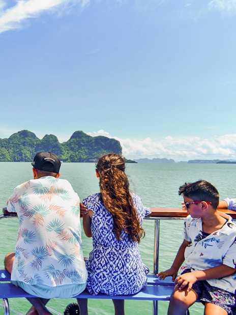 Tourists on a boat viewing James Bond Island and Phang Nga Bay, Thailand.