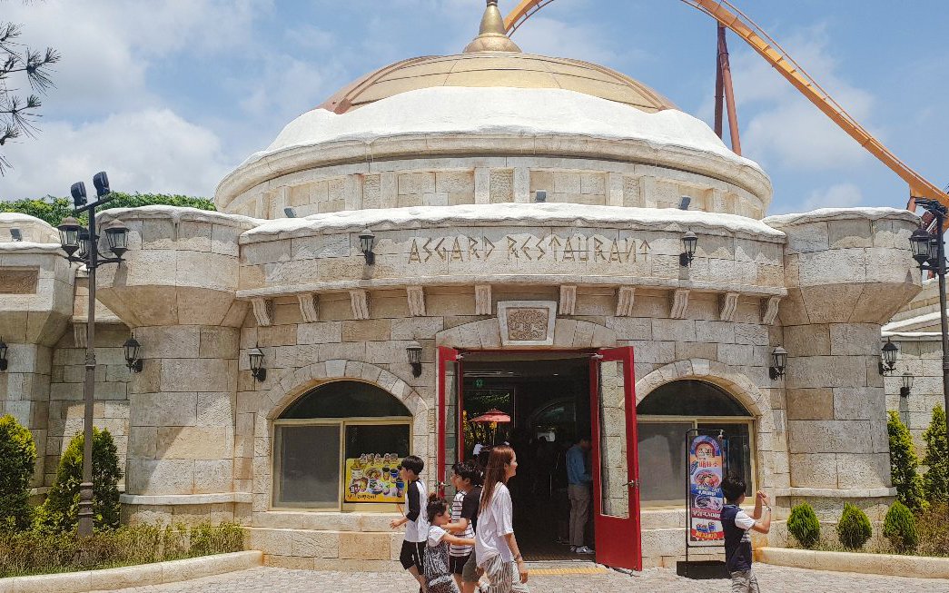 Asgard Restaurant entrance at Gyeongju World, South Korea, with visitors walking in.