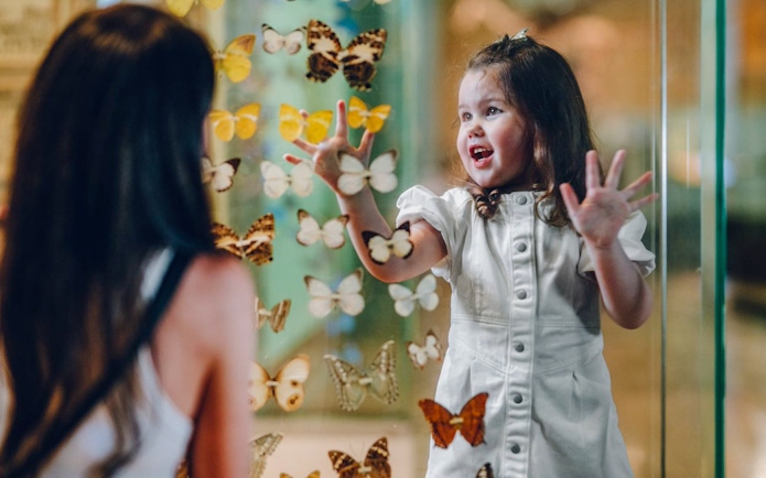 Children interacting with butterfly exhibit at Melbourne Museum.