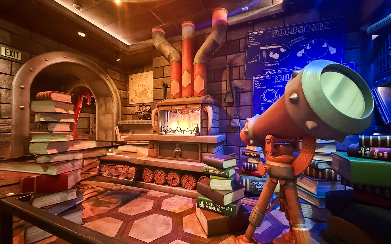 Universal Studios Hollywood attraction with telescope and stacked books in themed room.